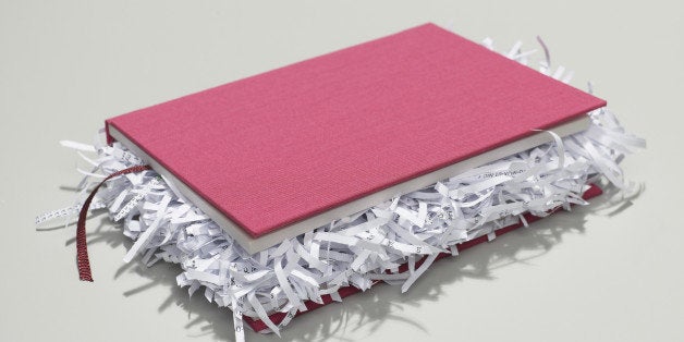 book with shredded pages closed on desk