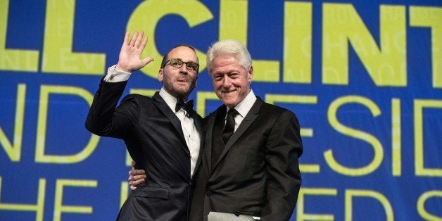 Former US president Bill Clinton (R) and Human Rights Campaign (HRC) president Chad Griffin acknowledge the crowd as Clinton arrives to address the 18th annual Human Rights Campaign National Dinner in Washington on October 25, 2014. HRC is the largest US civil rights organization working to achieve equality for lesbian, gay, bisexual and transgender people. AFP PHOTO/Nicholas KAMM (Photo credit should read NICHOLAS KAMM/AFP/Getty Images)