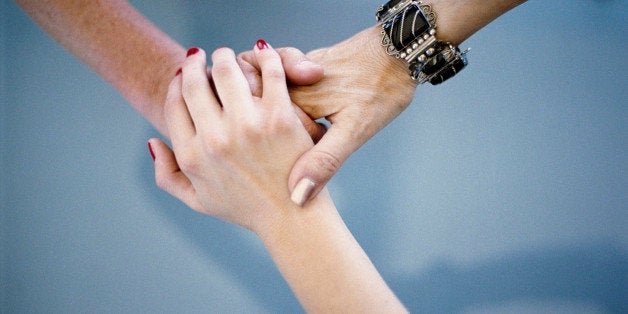 Close-up of women holding hands