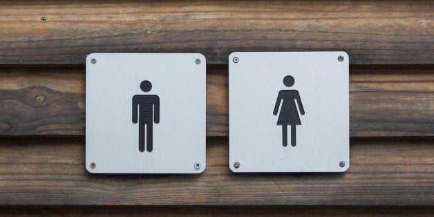 Man and a lady toilet sign, metal on wood