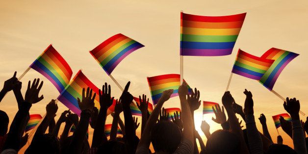 Group of People Waving Gay Pride Symbol Flags
