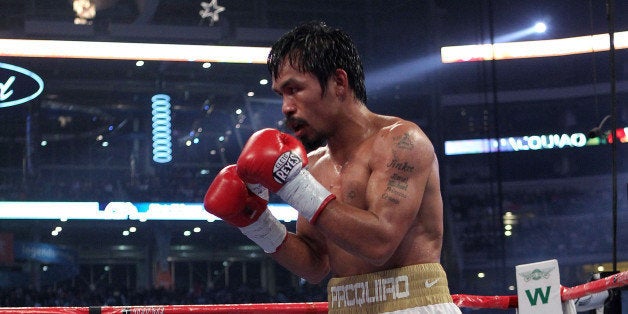 ARLINGTON, TX - NOVEMBER 13: Manny Pacquiao (white trunks) of the Philippines fights against Antonio Margarito of Mexico dur