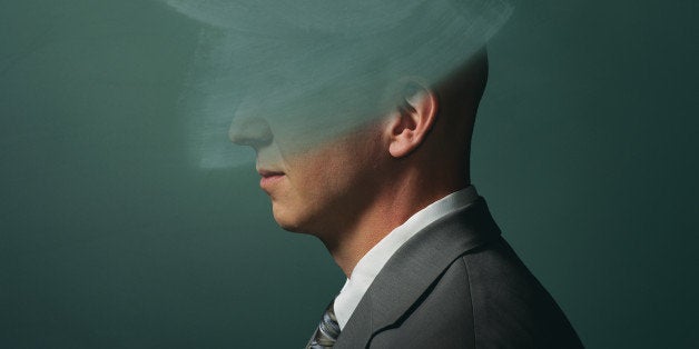 Man in front of chalkboard with head erased