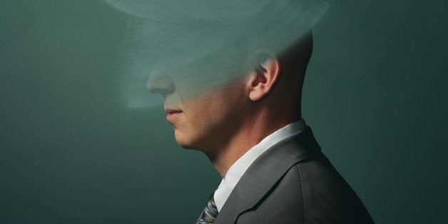 Man in front of chalkboard with head erased