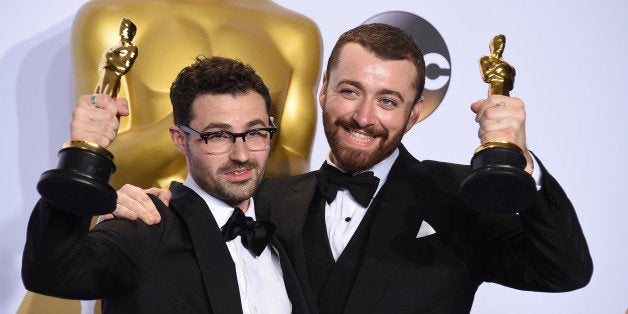 Jimmy Napes, left, and Sam Smith pose in the press room with the award for best original song for âWritingâs On The Wallâ