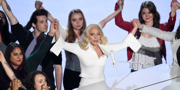 HOLLYWOOD, CA - FEBRUARY 28: Singer-songwriter Lady Gaga (C) performs onstage during the 88th Annual Academy Awards at the