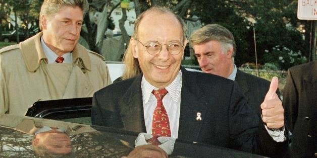 ISLAND PARK, UNITED STATES: Republican Senator Alfonse D'Amato gives the thumbs-up to the media as he climbs into his car to