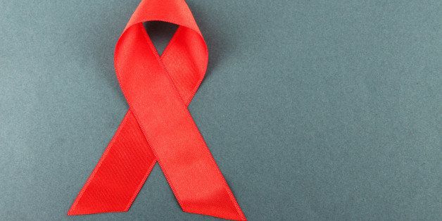 red ribbon hiv aids on gray...