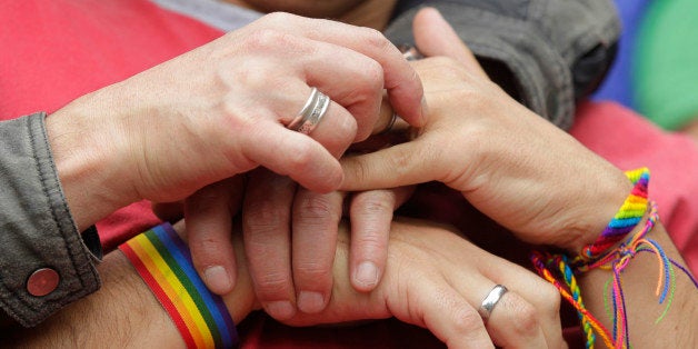People hold hands during a protest demanding the rights of the lesbian, gay, bisexual, and transgender (LGBT) community, at t