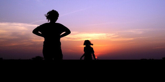 mother & daughter enjoying sunset.