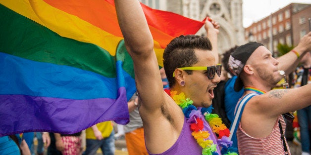 Gay couple marching in Gay Pride