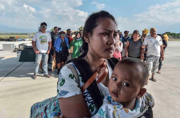 People injured or affected by the earthquake and tsunami wait to be evacuated on an air force plane in Palu, Central Sulawesi, Indonesia.