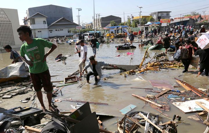 People survey the damage of a shopping centre following earthquakes and a tsunami in Palu, Central Sulawesi, Indonesia.