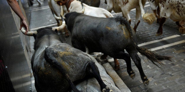 Jose Escolar Gil fighting bulls take Estafeta corner during the third running of the bulls at the San Fermin festival in Pamplona, northern Spain, July 9, 2016. REUTERS/Eloy Alonso