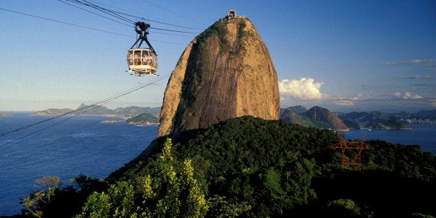 RIO DE JANEIRO, BRAZIL - 2015/10/04: Frontal view of Sugar Loaf cable car and mountain, urban forest, entrance of Guanabara B