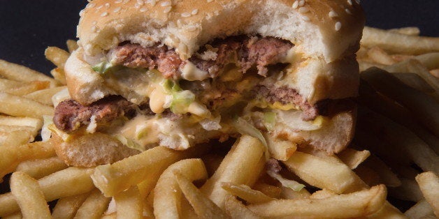 A photo of a partially eaten McDonalds' Big Mac hamburger atop French Fries, November 2, 2010. AFP Photo/Paul J. Richard