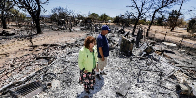 OAK HILLS, CA - AUGUST 19: Miguel and Mabel Ramos, both 73-year-old, are traumatized by the devastation caused by Blue Cut Fire that swept through his residence, on 6500 block of Oak Hill Road, burning guest house to grond, burning two cars and killing about 135 animals Oak Hills. (Photo by Irfan Khan/Los Angeles Times via Getty Images)