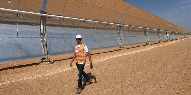 A worker walks walks in front of a solar array that is part of the Noor 1 solar power project in Ouarzazate on October 19, 2014. Morocco's first solar energy plant will begin operating in 2015, an official said, as part of a multi-billion-euro project the oil-scarce kingdom hopes will satisfy its growing energy needs. The Nour 1 plant cost 600 million euros (USD 765 million) and is expected to have a capacity to generate 160 MW. AFP PHOTO/ FADEL SENNA (Photo credit should read FADEL SENNA/AFP/Getty Images)