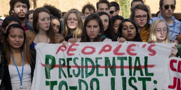 American students protest outside the UN climate talks during the COP22 international climate conference in Marrakesh in reaction to Donald Trump's victory in the US presidential election, on November 9, 2016.Stunned participants at UN climate talks in Marrakesh insisted that climate change denier Donald Trump cannot derail the global shift to clean energy, although some called his victory in US presidential elections a 'disaster'. / AFP / FADEL SENNA (Photo credit should read FADEL SENNA/AFP/Getty Images)