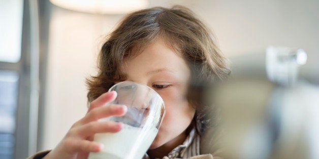 Close-up of a boy drinking a glass of milk