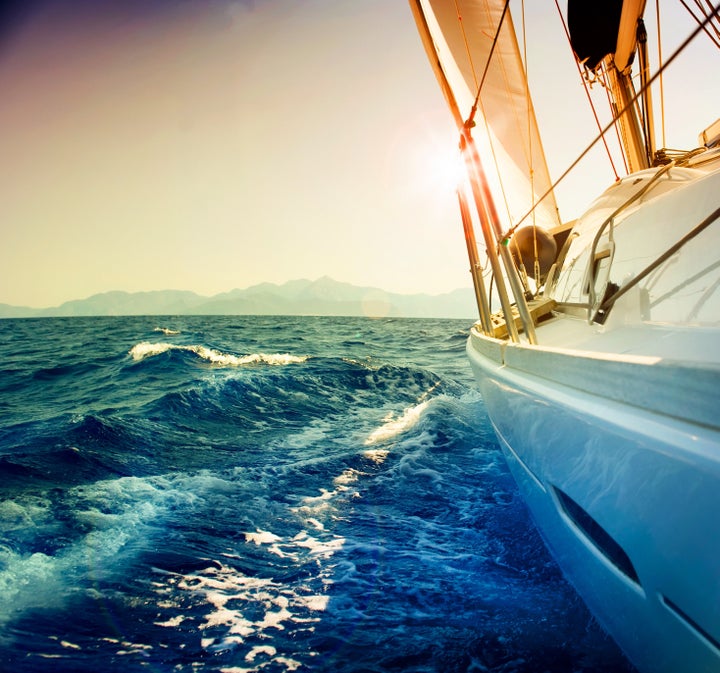 Yacht Sailing against sunset.Sailboat.Sepia toned