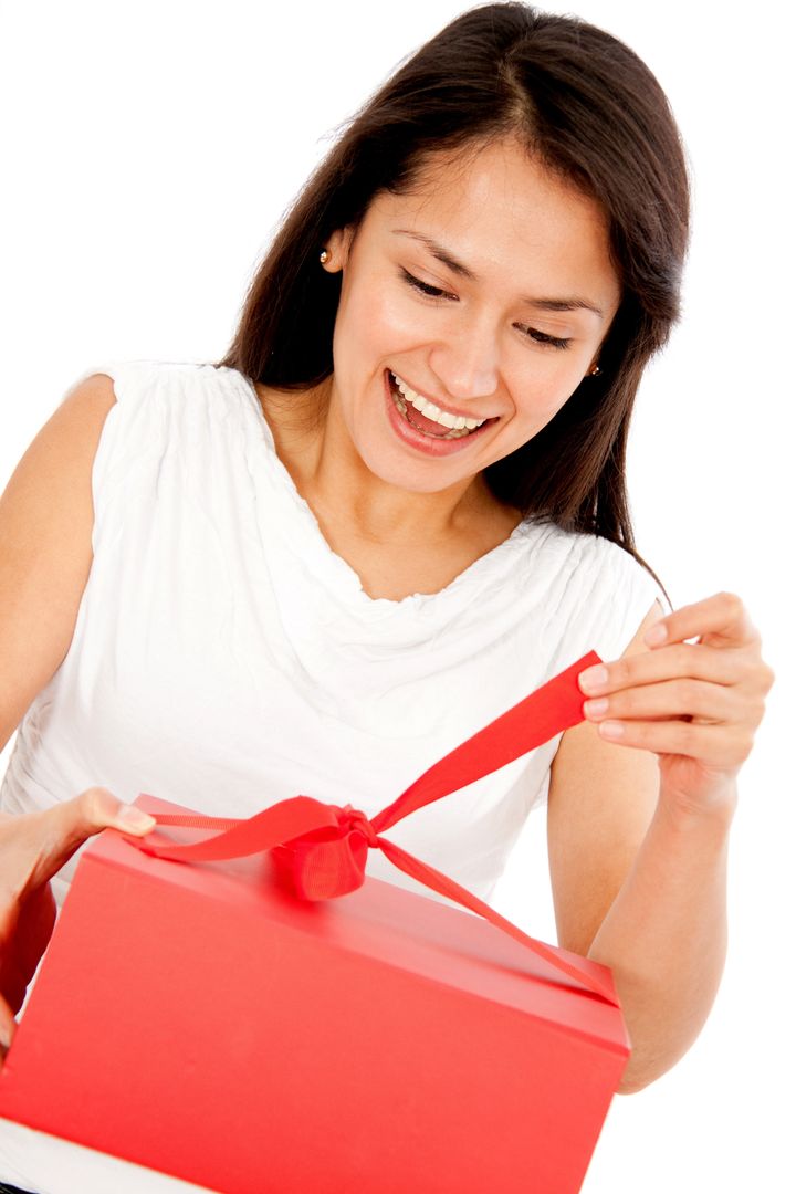 Happy woman opening a present - isolated over white