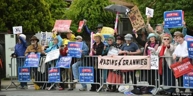 Protesters shout slogans regarding the Keystone XL pipeline as US President Barack Obama arrive in Atherton, California, on April 4, 2013. Obama is in California to attend two DCCC fund rising events. AFP PHOTO/Jewel Samad (Photo credit should read JEWEL SAMAD/AFP/Getty Images)