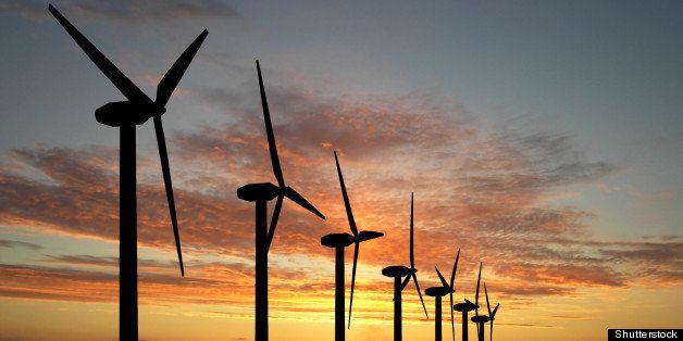 wind turbine farm over sunset