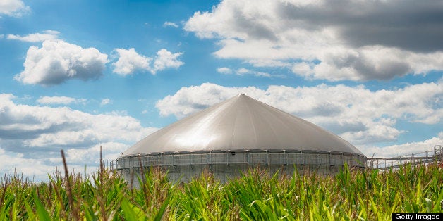 Wide angle shot of a modern biogas plant under a great cloudscape.