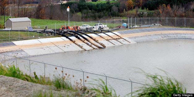 Southwestern Energy Co. pipes water from a nearby river to a holding pond on their site in Camptown, Pennsylvania, U.S., on Wednesday, Oct. 19, 2011. The wells are producing natural gas from the Marcellus Shale formation. The Marcellus Shale, located in the U.S. Northeast, contains natural gas, which is obtained through hydraulic fracturing, a technique in which millions of gallons of water, sand and chemicals are pumped underground to break apart the rock. Photographer: Julia Schmalz/Bloomberg via Getty Images