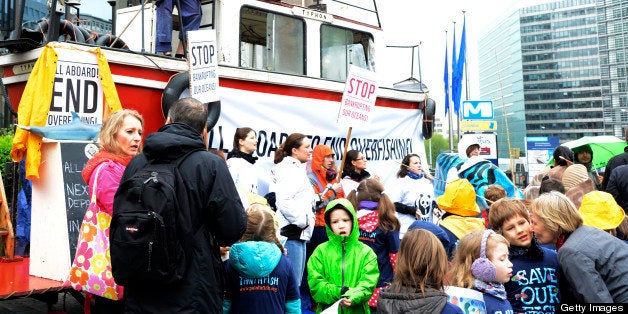 A few supporters of the conservationist body WWF, some of them standing on a boat, stage a protest against overfishing holding placards reading 'Stop Bankrupting our Oceans' in front of the European Union Council building in Brussels on May 13, 2013 during an EU Agriculture and Fisheries Council meeting. AFP PHOTO/ THIERRY CHARLIER (Photo credit should read THIERRY CHARLIER/AFP/Getty Images)