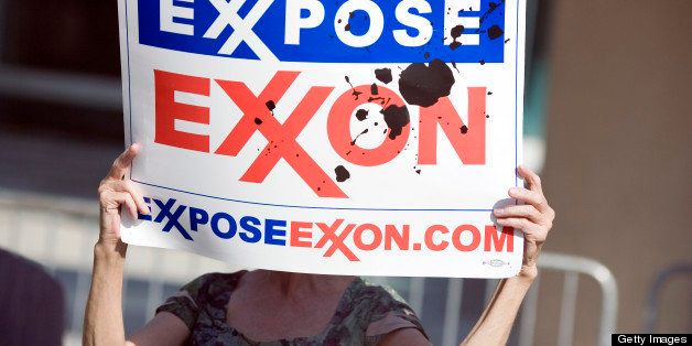 DALLAS - MAY 28: A protester holds a sign outside of the ExxonMobil annual shareholders meeting at the Morton H. Meyerson Symphony Center May 28, 2008 in Dallas, Texas. A total of 19 resolutions will be voted on today by shareholders. (Photo by Brian Harkin/Getty Images)