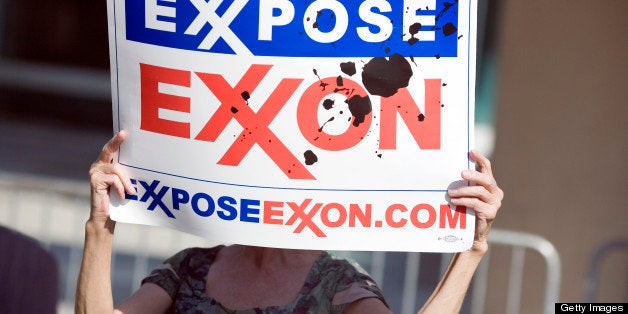 DALLAS - MAY 28: A protester holds a sign outside of the ExxonMobil annual shareholders meeting at the Morton H. Meyerson Sy