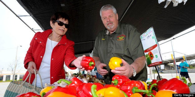 TORONTO, ON - MAY 3: Deborah Couz (left) helps to run the market and is seen getting schooled on the finer points of pepper selection from Ralph Lise of Ralph and Emmy Lise farms from Holland Marsh. The Farmer's market at Sherway Gardens has been operating for 20 years. Friday May 3 is the first day of the new season for the market in the far corner of the parking lot. (Richard Lautens/Toronto Star via Getty Images)