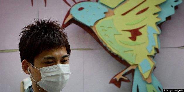 A men wears a face mask as the city's commuters protect themselves against the H7N9 bird flu virus in the downtown area of Shanghai on April 16, 2013. Chinese state media on April 15 urged people to keep eating chicken and help revive the poultry industry, which lost 1.6 billion USD in the week after the H7N9 bird flu virus began infecting humans and a total of 63 people have been confirmed as infected and 14 have died in the two weeks. AFP PHOTO / Mark RALSTON (Photo credit should read MARK RALSTON/AFP/Getty Images)