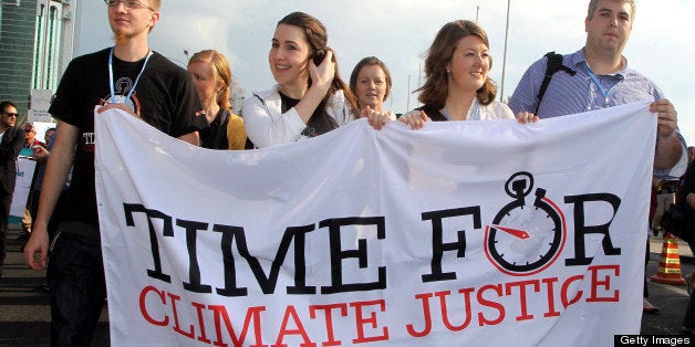 Activists carry placards during a rally in Doha on December 1, 2012 to demand urgent action addressing climate change as the United Nations Convention on Climate Change continues in the Qatari capital. The chances of hitting the UN's global warming target are diminishing, but the goal can still be met if greenhouse-gas emissions fall by 15 percent by 2020, scientists said. AFP PHOTO / AL-WATAN DOHA / KARIM JAAFAR == QATAR OUT == (Photo credit should read KARIM JAAFAR/AFP/Getty Images)