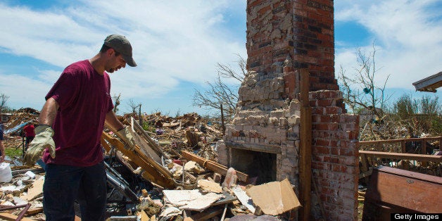 MOORE, OK - MAY 22: Justin Stephan walks around his tornado destroyed home looking for keepsakes on May 22, 2013 in Moore, Ok