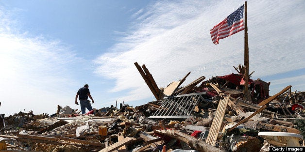 MOORE, OK - MAY 23: Stan Mallette searches through the rubble of his son's home on May 23, 2013 in Moore, Oklahoma. The torn