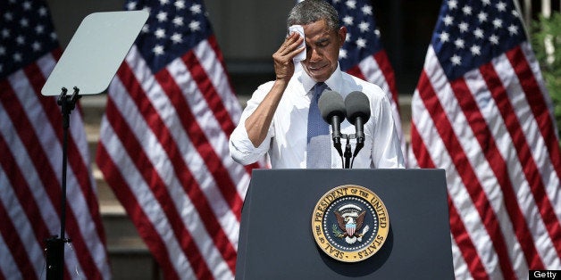 WASHINGTON, DC - JUNE 25: U.S. President Barack Obama wipes sweat off his face as he unveils his plan on climate change June 25, 2013 at Georgetown University in Washington, DC. President Obama laid out his plan to diminish carbon pollution and prepare the country for the impacts of climate change. (Photo by Alex Wong/Getty Images)