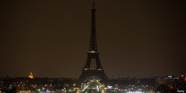 The Eiffel tower is seen before submerging into darkness at 8:30 pm (local time) as part of the Earth Hour switch-off on Marc