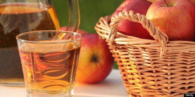 Basket with apples and apple juice in glass.