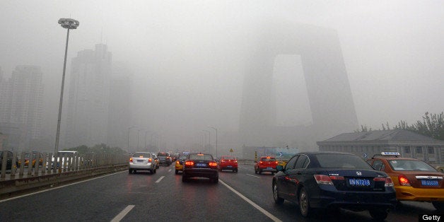 This picture taken on June 5, 2013 shows vehicles under heavy smog in Beijing. The capital has seen 46 smog days among the 1