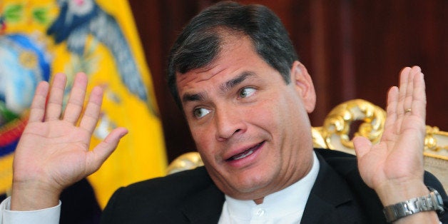 Ecuadorean President Rafael Corrrea getures during an interview with AFP in his office at the Carondelet Palace in Quito, on