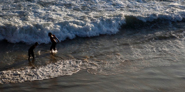 Children play in the waves in the Pacific Ocean north of the Santa Monica Pier in Santa Monica, California, U.S., on Monday,