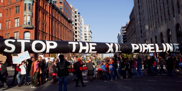 A mock oil pipeline is carried during a Keystone XL tar sands oil pipeline demonstration near the White House in Washington, D.C., U.S., on Sunday, Nov. 6, 2011. Pipeline opponents say extracting crude from sand emits three times more carbon than conventional oil production, contributing to global warming that Obama pledged to fight. They say their protest in Washington reflects public anger at corporate greed. Photographer: Andrew Harrer/Bloomberg via Getty Images