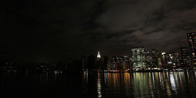 The darkened skyline of lower Manhattan is seen one day after Hurricane Sandy on October 30, 2012. Life ground to a virtual halt in parts of southern Manhattan still without power, but many New Yorkers seemed to be taking the damage wrought by Hurricane Sandy in stride. AFP PHOTO /Mehdi Taamallah (Photo credit should read MEHDI TAAMALLAH/AFP/Getty Images)