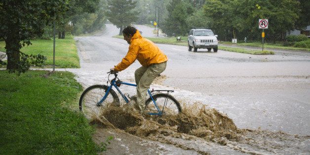 BOULDER, CO - SEPTEMBER 12: Pro mountain biker Joey Schusler tests his skills along Canyon Boulevard September 12, 2013 in Boulder, Colorado. An estimated 6-10 inches of rain fell in 12-18 hours and more is expected throughout the day. Flash flood sirens warned people to stay away from Boulder Creek and seek higher ground. (Photo by Dana Romanoff/Getty Images)