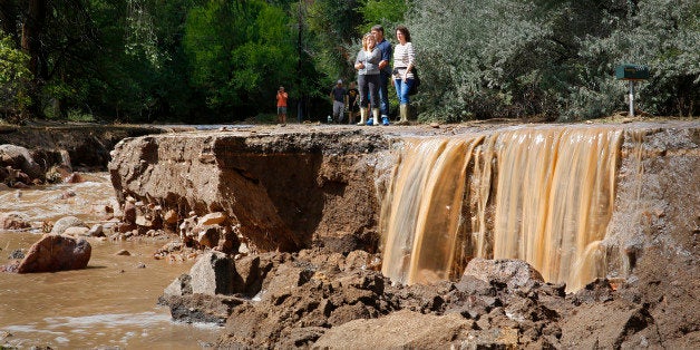 BOULDER, CO - SEPTEMBER 13: Local residents look at the damage along Topaz Street September 13, 2013 in Boulder, Colorado. Heavy rains for the better part of week has fueled widespread flooding and evacuations in numerous Colorado towns, with the area reportedly already having received 15 inches of rain. Photo by Marc Piscotty/Getty Images)