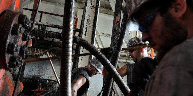 SLUG: NA_PAOIL DATE: July 31, 2008 PLACE: Amwell, PA CREDIT: jahi chikwendiu/twp From left, Todd Owen of Sandusky, MI, Greg Sereno of Osceola, PA. and Joshua 'Hoss' McGraw of Dennison, OH, maintain a natural gas drilling rig as Range Resources is drilling aggressively in the rolling farmland in Amwell, PA, which is just southwest of Pittsburgh. Heavy industry has invaded the countryside because of something called the Marcellus Shale. Its a layer of hard, black rock, more than a mile down. Trapped in tiny pores of that rock is a huge quantity of natural gas. The Marcellus Shale could become what people in the natural gas business call a big play. ՒIts a gold rush, really. It's a boom, said Steve Rupert, an executive with Range Resources. (Photo by Jahi Chikwendiu/The Washington Post/Getty Images)