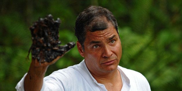 Ecuadorean President Rafael Correa shows his oil-covered hand at Aguarico 4 oil well in Aguarico, Ecuador on September 17, 2013. Aguarico 4 was operated by US oil company Texaco between 1962 and 1990. Correa called Tuesday for a global boycott of Chevron, as part of a campaign to highlight Amazon environmental damage Ecuador attributed to the US oil giant. Chevron has never worked directly in Ecuador but inherited a pollution lawsuit when it acquired Texaco in 2001, and has yet to pay an associated fine. AFP PHOTO / RODRIGO BUENDIA (Photo credit should read RODRIGO BUENDIA/AFP/Getty Images)